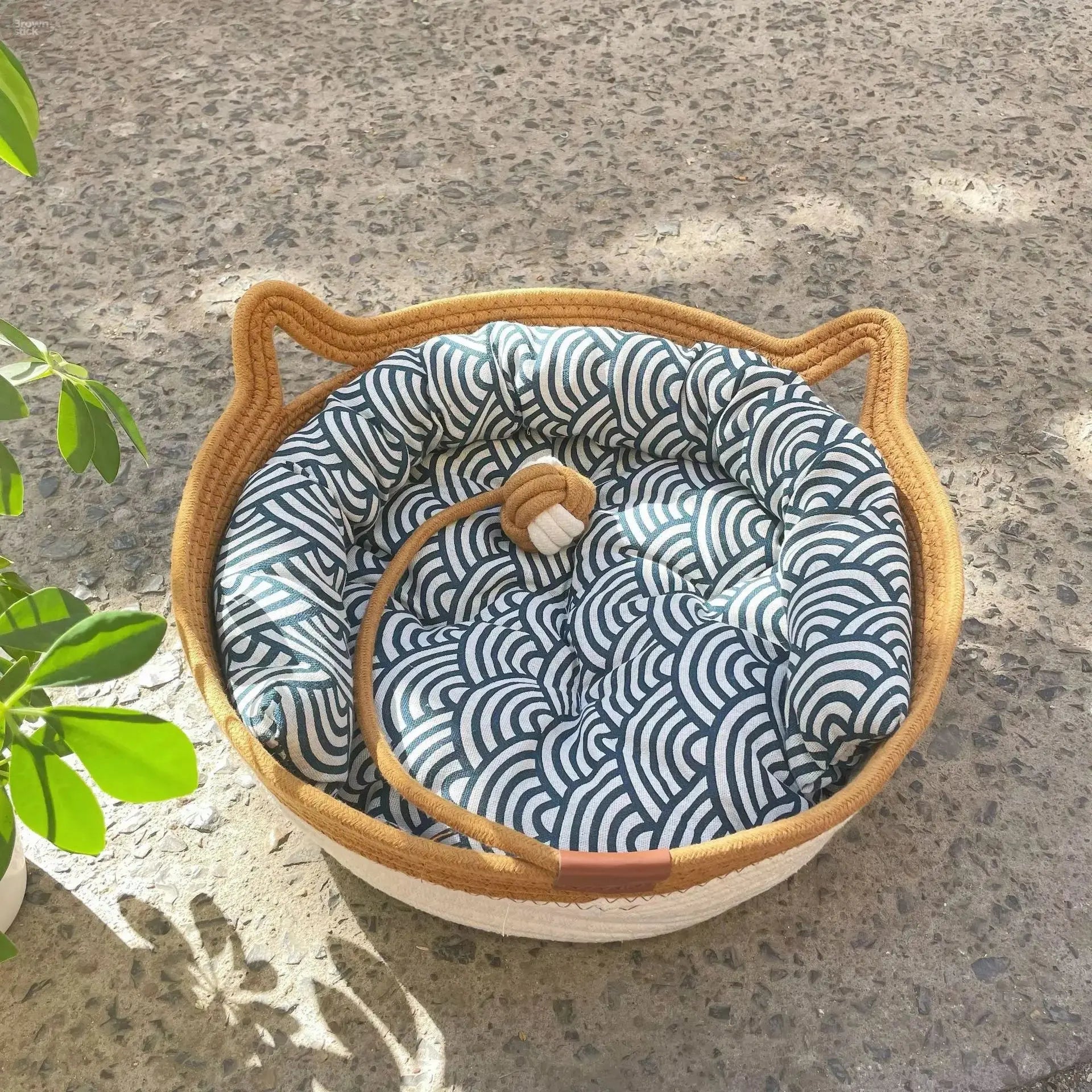 A woven cat bed featuring a removable and washable rattan design Brownstick